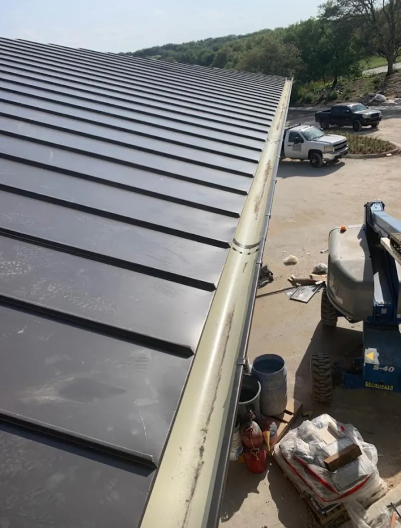 Standing seam panel and gutter detail on a metal roofing jobsite in Pinewood